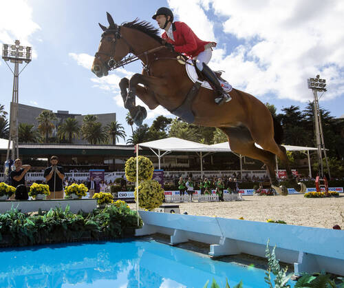 Pieter Devos of Belgium rides Claire Z over the water jump to help the Belgium team win the Longines FEI Jumping Nations Cup Final held in the Real Club de Polo in Barcelona, Spain, 07 October 2018.  Photo FEI/Jim Hollander
