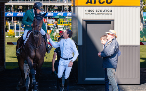 Bertram Allen (IRL) is congratulated on a great round by teammate Conor Swail (IRL) © Spruce Meadows Media/Bart Onyszko