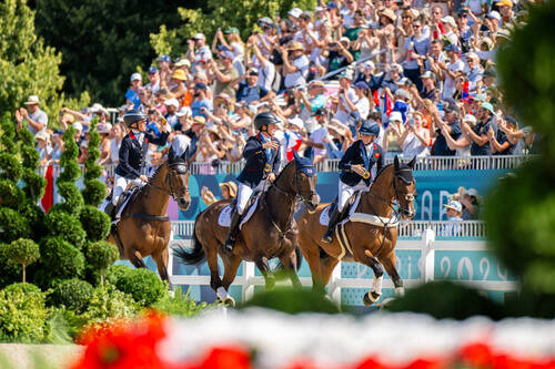 Team Gold Eventing Winners:     L-R: Rosalind Canter (GBR), Laura Collett (GBR) and Tom McEwen (GBR) at the Chateau de Versailles for the Paris 2024 Olympic Games.     Photo Credit: FEI/Benjamin Clark